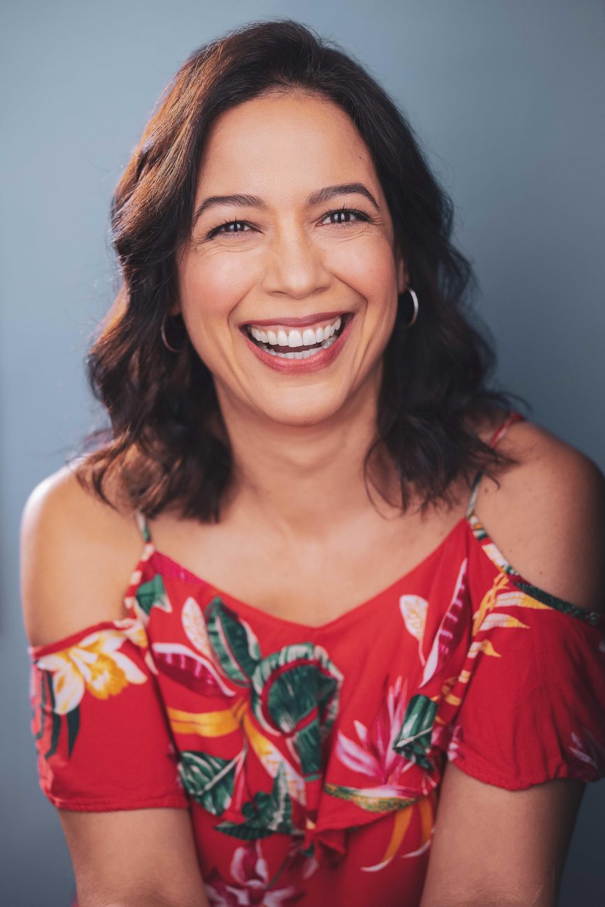 Gredivel Vasquez headshot — red floral, smiling