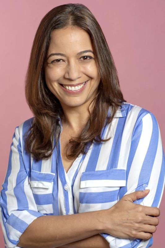 Gredivel Vasquez headshot — striped shirt, pink